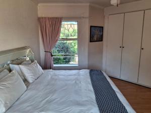 Ένα ή περισσότερα κρεβάτια σε δωμάτιο στο Papillon Guesthouse