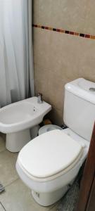 a bathroom with a white toilet and a sink at Monoambiente M y L in La Plata