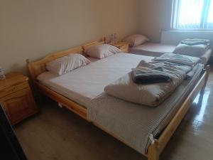 two twin beds in a room with at Guest Rooms Didka in Koprivshtitsa