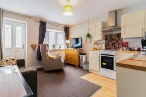 a kitchen with a couch and a chair in a room at Private Flat in Warwickshire in Warwick