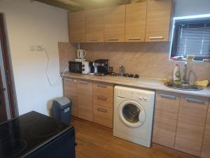 a kitchen with a washing machine and a sink at Guest Rooms Didka in Koprivshtitsa