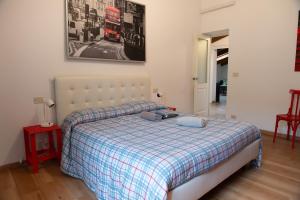 a bedroom with a bed with a plaid blanket at Historic center Teatro Regio appartamento Luca in Parma
