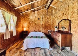 a bedroom with a bed and a wooden wall at Cabañas Los Saucos in Valle de Bravo +40 photos