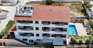an aerial view of a white building with a swimming pool at La Perla apartments 3 in Sutivan