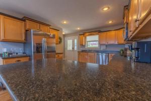 a large kitchen with a granite counter top at Harborview at Lake Cumberland in Somerset