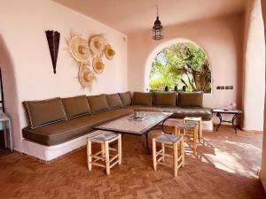 a living room with a couch and a table at Palais Al Moun in Essaouira