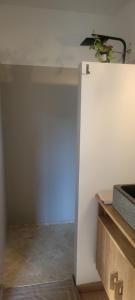 a room with a white wall with a potted plant at Chambres d hôtes les Romarins in Cantaron