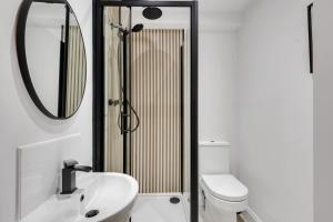 a bathroom with a sink and a toilet and a mirror at Earl Grey at The Tea Warehouse - North East Escapes in Alnwick +12 photos