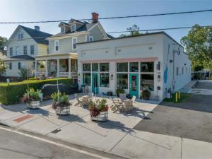 a building with plants and chairs in front of it at The Hidden Hideaway on College in Macon