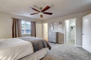 a bedroom with a bed and a ceiling fan at The Eastside Townhome Of Ophir in Anchorage