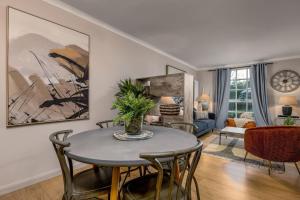 a living room with a table and chairs at The Mill Retreat in Stirling