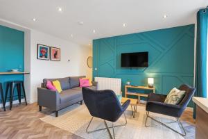 a living room with a couch and chairs at Darjeeling at The Tea Warehouse - North East Escapes in Alnwick