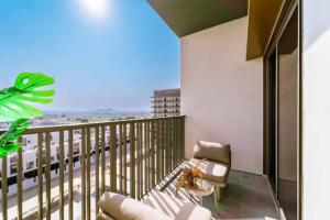 a balcony with a glass table and a view of a city at 017 - Mag 900 in Umm Al Quwain