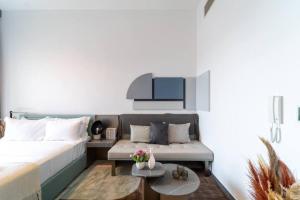 a living room with a bed and a couch at 017 - Mag 900 in Umm Al Quwain +1 photo
