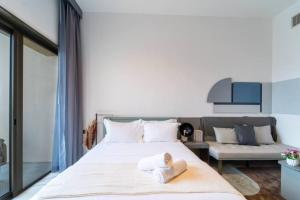 a bedroom with a large bed with towels on it at 017 - Mag 900 in Umm Al Quwain