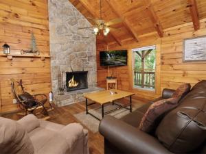 a living room with a couch and a fireplace at Country Romance - Peaceful Getaway in Jones Cove