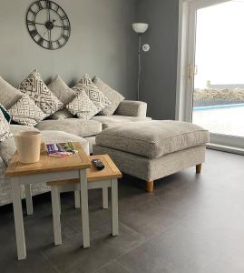a living room with a couch and a coffee table at Number Forty Two, Portsoy - A 3 bedroom cottage with sea views in Portsoy