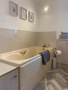 a bathroom with a large tub in a room at Number Forty Two, Portsoy - A 3 bedroom cottage with sea views in Portsoy