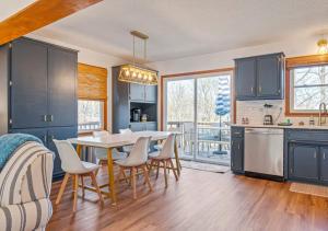 a kitchen with blue cabinets and a table and chairs at Lucky Dozen Lakehouse in Winchester