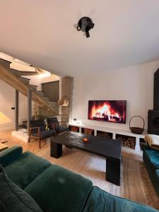 a living room with a couch and a fireplace at Casa boutique-rural en El Bierzo in Torre del Bierzo