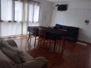 ein Wohnzimmer mit Tisch und Stühlen und einer Couch in der Unterkunft Departamento centro Mendoza a Pasos de la terminal in Barraquero