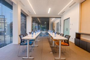 a conference room with long tables and chairs at Seen Hotel Abidjan Plateau in Abidjan