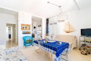 a living room with a blue table and chairs at Vista mare Charme Apartament in Porto Cesareo