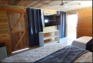 a bedroom with a sliding barn door and a bed at Vista Montaña Jimenoa De La Rosa in Jarabacoa +27 photos