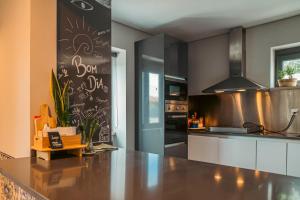 a kitchen with a counter top in a kitchen at Villa Caparica Hostel in Costa da Caparica