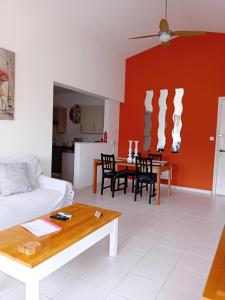 a living room with a couch and a table at Tala Gardens Apartment in Tala
