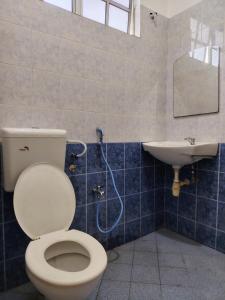 a bathroom with a toilet and a sink at Pearl Villa 5 Bedroom Unit 6 in Port Dickson +8 photos