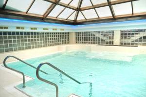 a large indoor swimming pool with a glass ceiling at Grand Hotel Telese in Telese