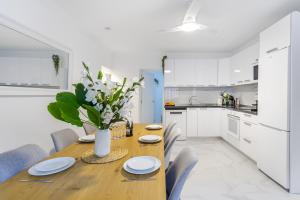 a kitchen and dining room with a wooden table and chairs at House of dreams in Mogán