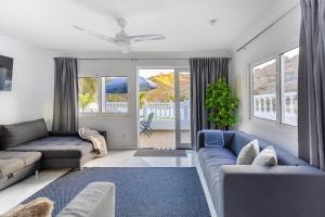 a living room with blue couches and a blue rug at House of dreams in Mogán