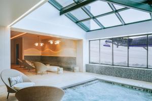 a room with a swimming pool and a table and chairs at Summit Hotel at Big Sky Resort in Big Sky