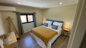 a bedroom with a bed and a window at Sapateiro Guest House in Tabuado