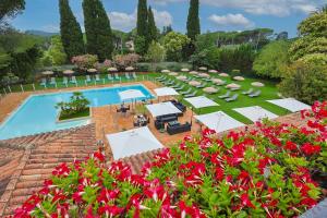 an overhead view of a pool with tables and chairs and flowers at Golf Hôtel de Valescure & Spa NUXE in Saint-Raphaël