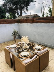 a table with chairs and plates on a patio at Charmante maison de ville in Thouars