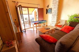 a living room with a couch and a table at Casa Rural El Planet de Maella Casa rural en Castellon Casa rural con Jacuzzi Casa rural en Xert Casa rural cerca de Morella in Xert