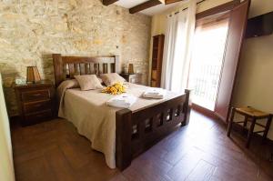a bedroom with a large bed with flowers on it at Casa Rural El Planet de Maella Casa rural en Castellon Casa rural con Jacuzzi Casa rural en Xert Casa rural cerca de Morella in Xert +91 photos