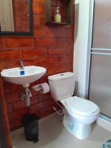 a bathroom with a toilet and a sink at Apartamento con vista al lago in Paipa +17 photos