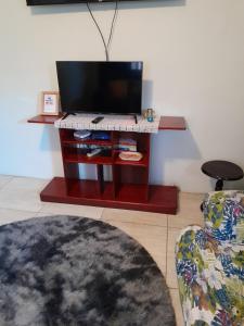 a living room with a television and a chair at GranAnn's Place in Kingston