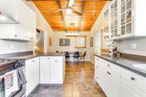 a kitchen with white cabinets and a wooden ceiling at Peaceful Vista House with Gas Grill 1 Mi to Dtwn! in Vista