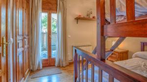 a bedroom with a bunk bed and a staircase in a room at Saplan Real Estate CALETA in Les