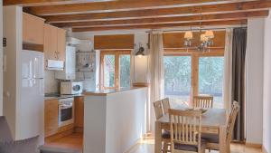 a kitchen with a table and a dining room at Saplan Real Estate CALETA in Les