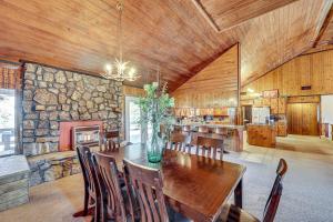a dining room with a table and a stone wall at 4 Mi to Lake Access Pet-Friendly Home in Bismarck in Bismarck