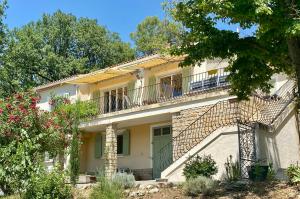 a large white house with a balcony at Villa Magrado in Entrecasteaux