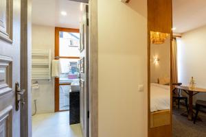 a hallway with a door leading to a room with a bedroom at Palm Tbilisi Boutique Hotel in Tbilisi City
