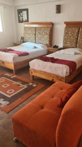Postel nebo postele na pokoji v ubytování Hotel Leyenda del Tepozteco