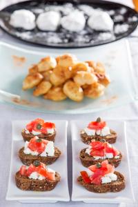 a group of appetizers on white plates on a table at Contaratos Beach Hotel in Naousa